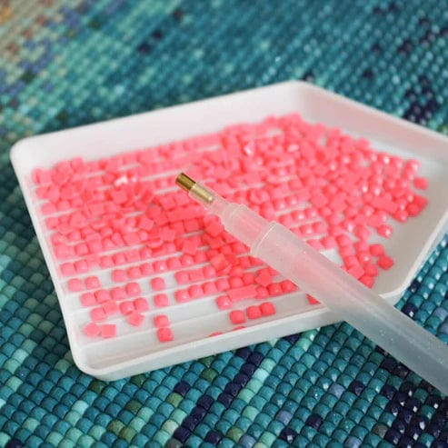 Tray of pink drill beads for custom diamond painting